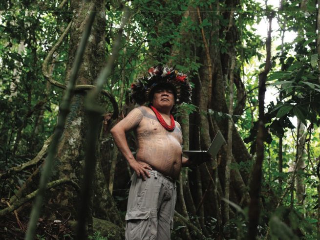 Man with laptop in rainforest